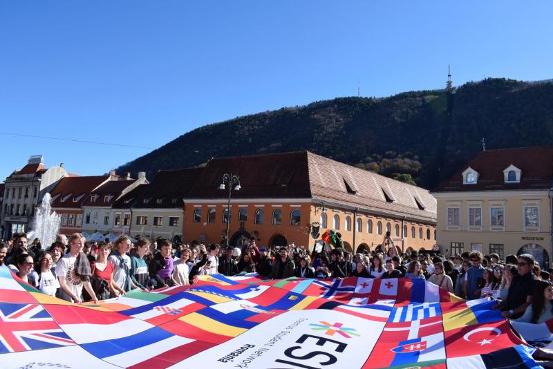 Scene from Halloween in Transylvania, showcasing studentsb behind the ESN UniBucharest flag
